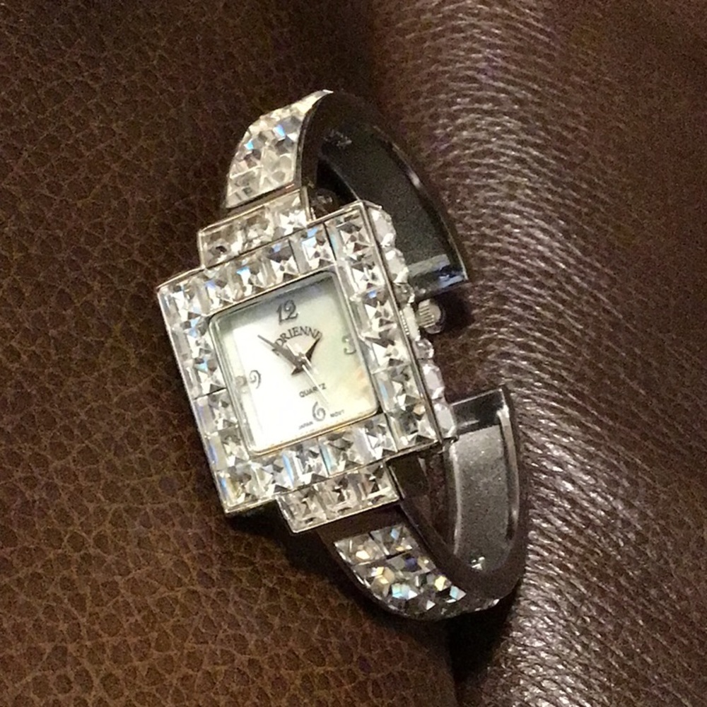 NWT,REAL COLLECTIBLES BY ADRIENNE CRYSTAL CUFF WATCH. LOTS OF GEMS, VERY CHIC.